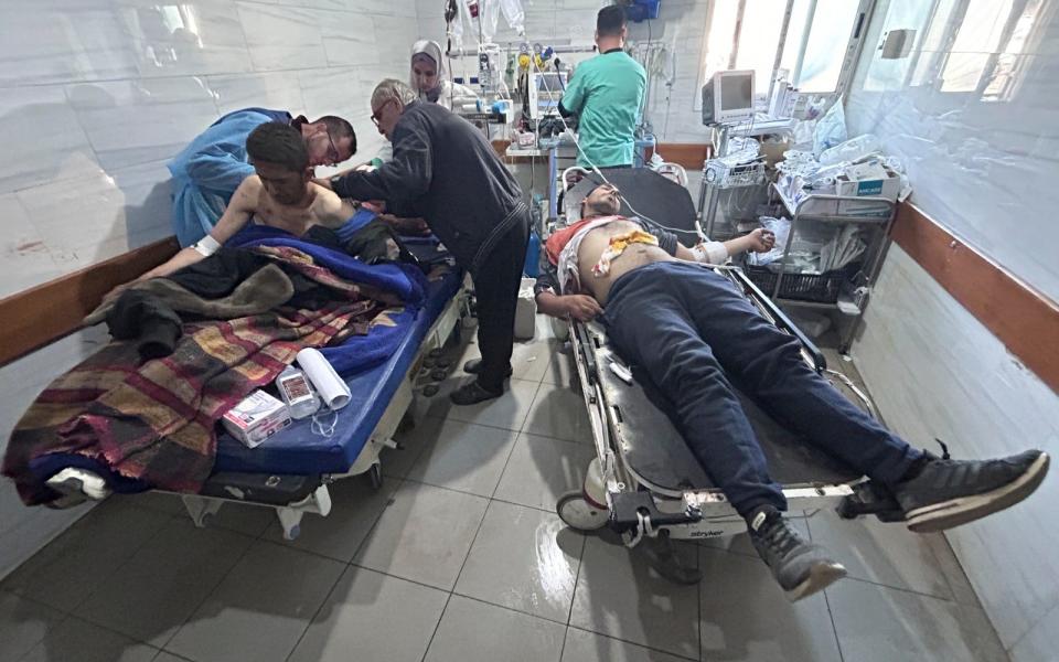 Palestinians wounded in an Israeli strike while waiting for humanitarian aid on the beach in Gaza City