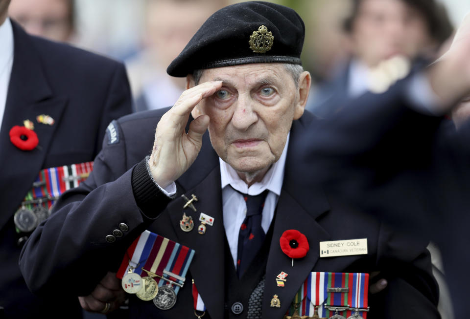 Canadian World War II veteran Sidney Cole salutes as he attends a ceremony at the Beny-sur-Mer Canadian War Cemetery in Reviers, Normandy, France, Wednesday, June 5, 2019. A ceremony was held on Wednesday for Canadians who fought and died on the beaches and in the bitter bridgehead battles of Normandy during World War II. (AP Photo/David Vincent)