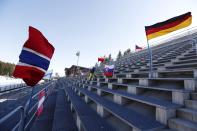 Flags wave on empty stands ahead of the women's Biathlon World Cup 7,5 km sprint event in Nove Mesto na Morave, Czech Republic, Thursday, March 5, 2020. Due to the coronavirus the Biathlon World Cup will take place without spectators. (AP Photo/Petr David Josek)