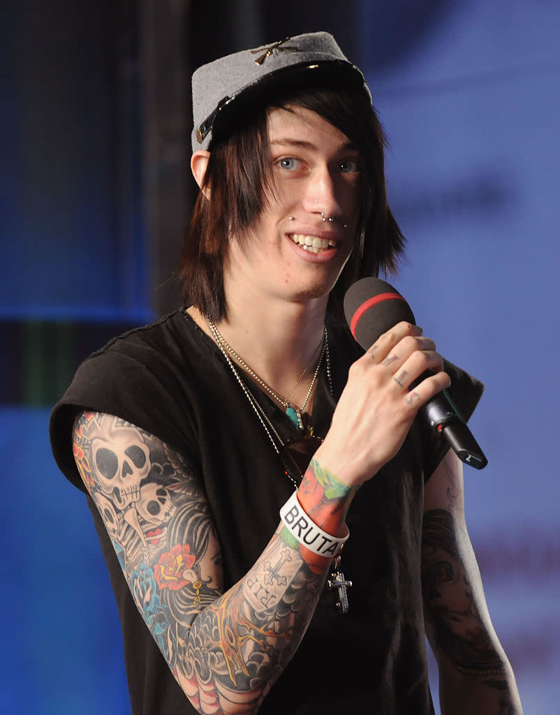 trace on stage with long straight hair and facial piercings