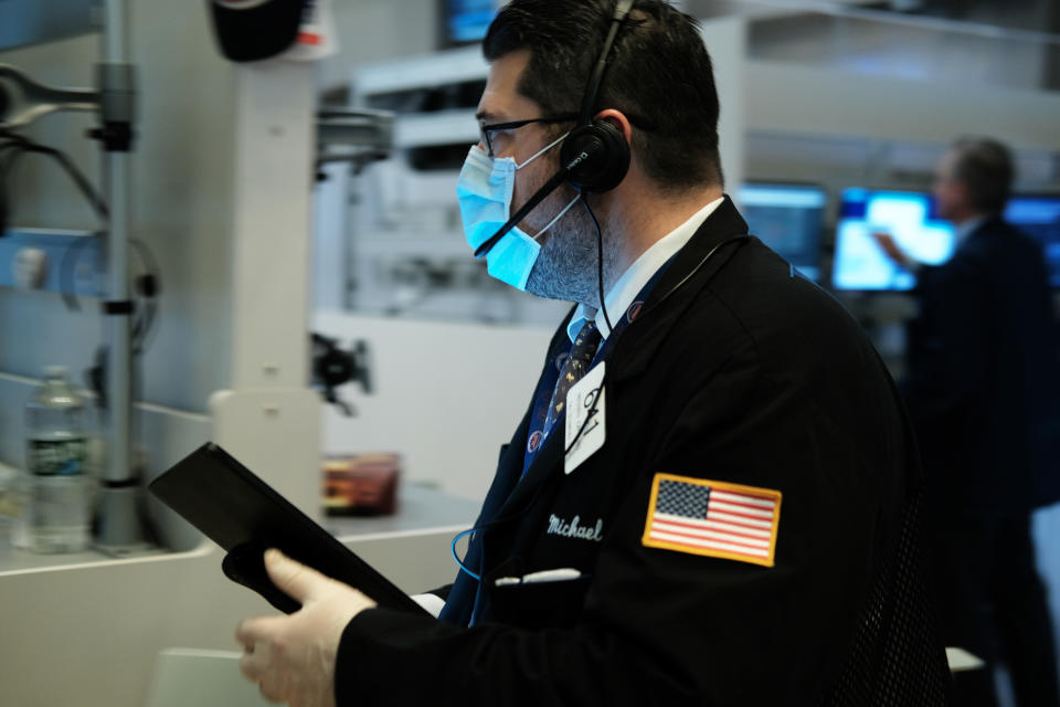 NEW YORK, NEW YORK - MARCH 20: Traders, some in medical masks, work on the floor of the New York Stock Exchange (NYSE) on March 20, 2020 in New York City. Trading on the floor will temporarily become fully electronic starting on Monday to protect employees from spreading the coronavirus. The Dow fell over 500 points on Friday as investors continue to show concerns over COVID-19.  (Photo by Spencer Platt/Getty Images)