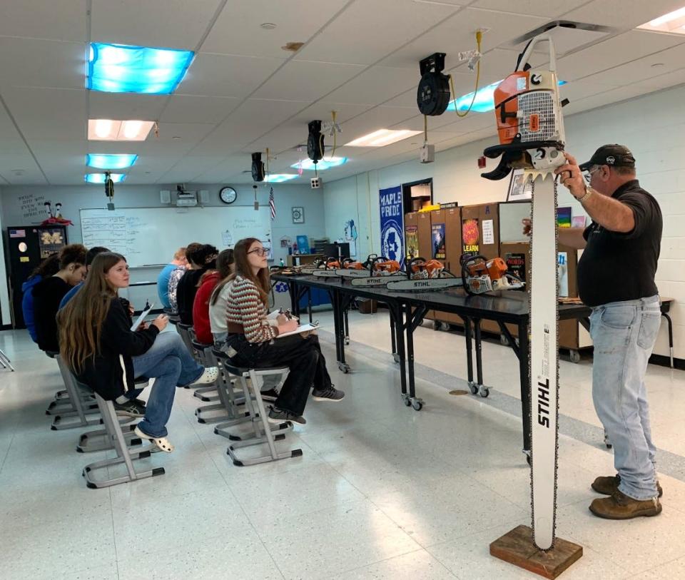 Craig Phillips of Redwood Tree Services was among the 10 individuals and businesses who spoke and visited with seventh grade students at Springbrook Middle School in Adrian during a career fair, which welcomed a collection of professionals to the school.
