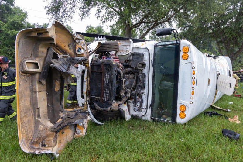 Authorities said the bus was sideswiped by a truck, causing the vehicle with more than 50 on board to drive off the road and into a tree, which caused it to overturn. Photo courtesy of Marion County Fire Rescue/Facebook