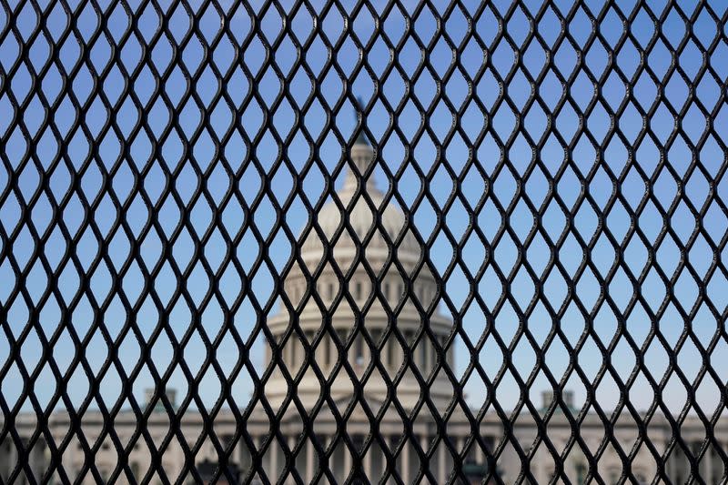 FILE PHOTO: The U.S. Capitol is seen through a security fence in Washington
