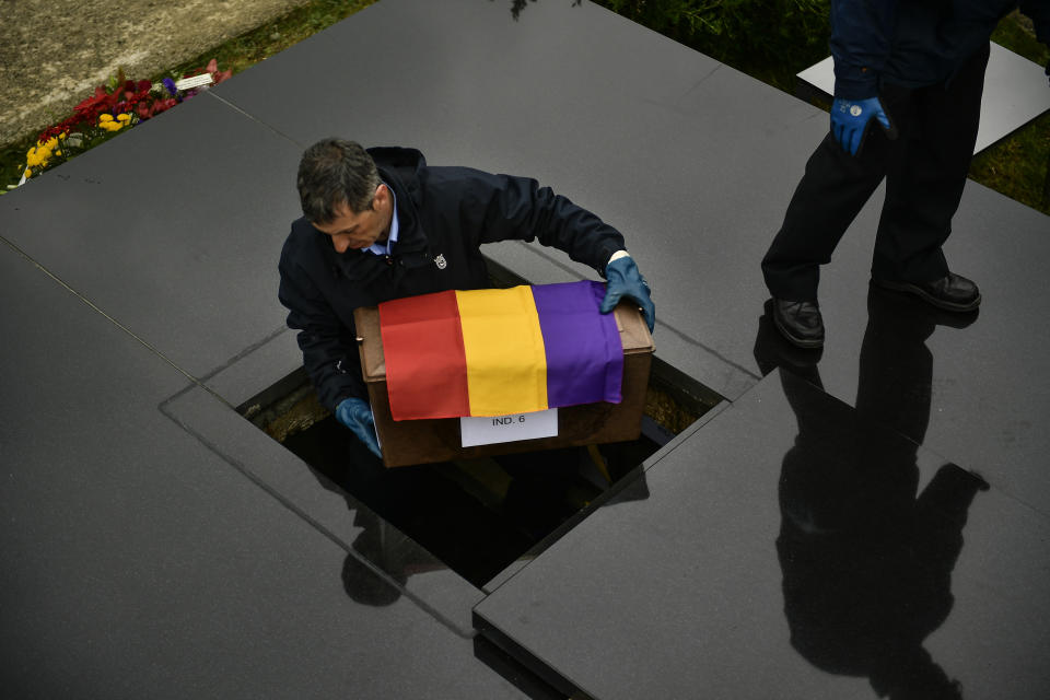 A man carries one of the 46 coffins of unidentified people killed during the Spanish Civil War, at San Jose cemetery, Pamplona, northern Spain, Monday, April 1, 2019. Marking eight decades since the end of the Spanish Civil War, the remains of 46 unidentified victims of the conflict have been reburied in the northern city of Pamplona. More than half a million people died in the 1936-1939 war between rebel nationalist forces led by Gen. Francisco Franco and defenders of the short-lived Spanish republic. (AP Photo/Alvaro Barrientos)