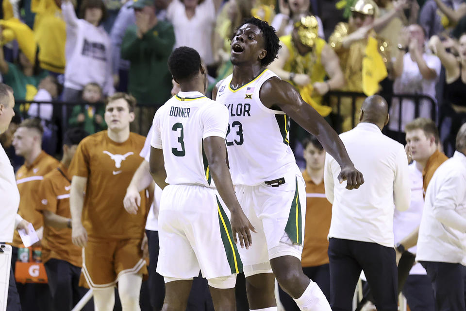 Baylor forward Jonathan Tchamwa Tchatchoua (23), right, and Baylor guard Dale Bonner (3) celebrate as they score against Texas during the second half of an NCAA college basketball game Saturday, Feb. 25, 2023, in Waco, Texas. (AP Photo/Jerry Larson