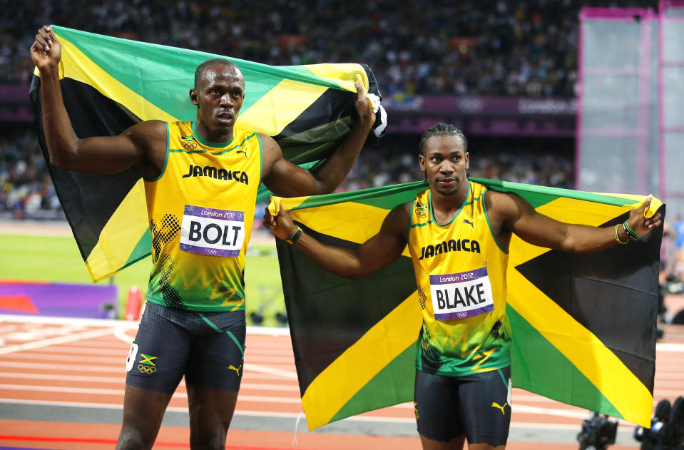 Jamaica's Usain Bolt (L) celebrates winning with countryman Yohan Blake who took second in the men's 100m final during the London 2012 Olympic Games at the Olympic stadium in London August 5, 2012. REUTERS/Brian Snyder (BRITAIN - Tags: SPORT ATHLETICS SPORT OLYMPICS) 