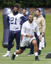 Dallas Cowboys running back Ezekiel Elliott (21) looks on as quarterback Dak Prescott warms-up during an NFL football team practice Tuesday, June 8, 2021, in Frisco, Texas. (AP Photo/LM Otero)