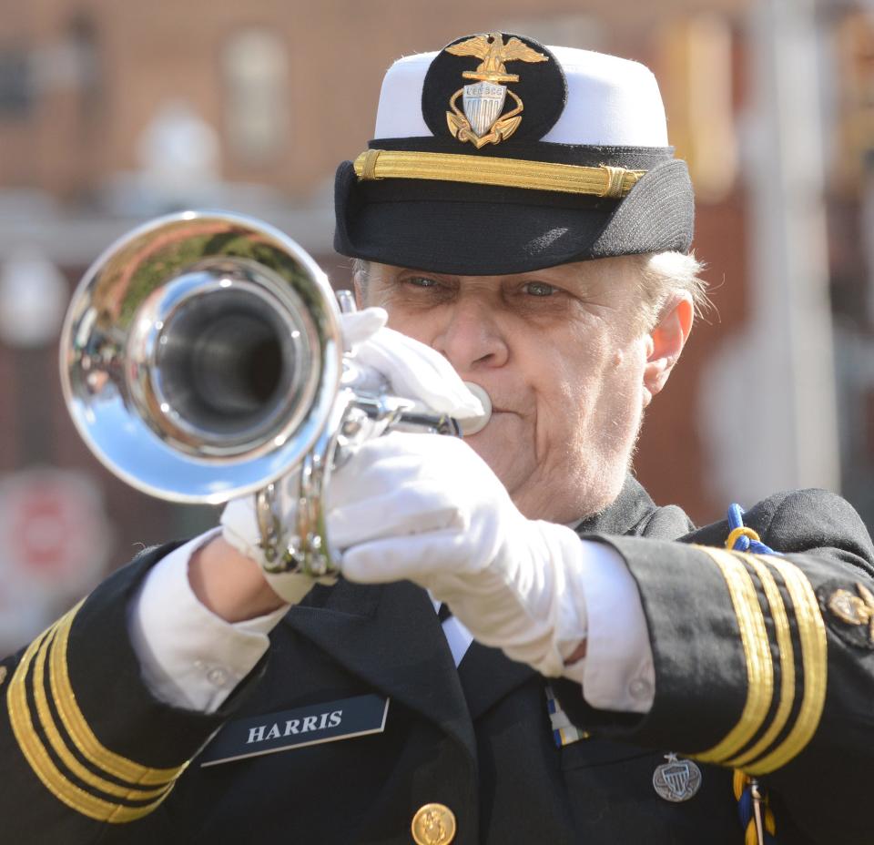 Retired Navy Lt. Commander Joyce Harris of Gales Ferry plays Taps Tuesday during Pearl Harbor Remembrance Day at Norwich City Hall.