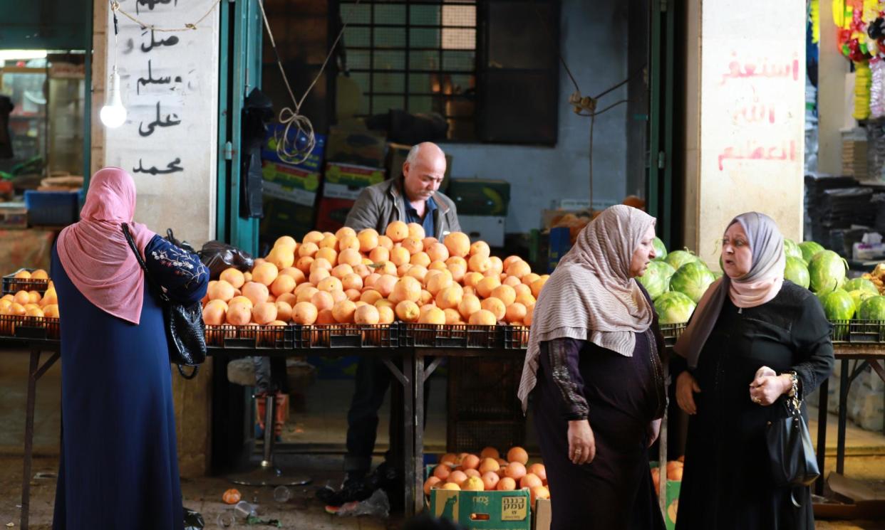 <span>Oranges and watermelons for sale at a market stall in Bethlehem. ‘There should be piles of aubergines and courgettes,’ says Kattan.</span><span>Photograph: Quique Kierszenbaum/The Guardian</span>