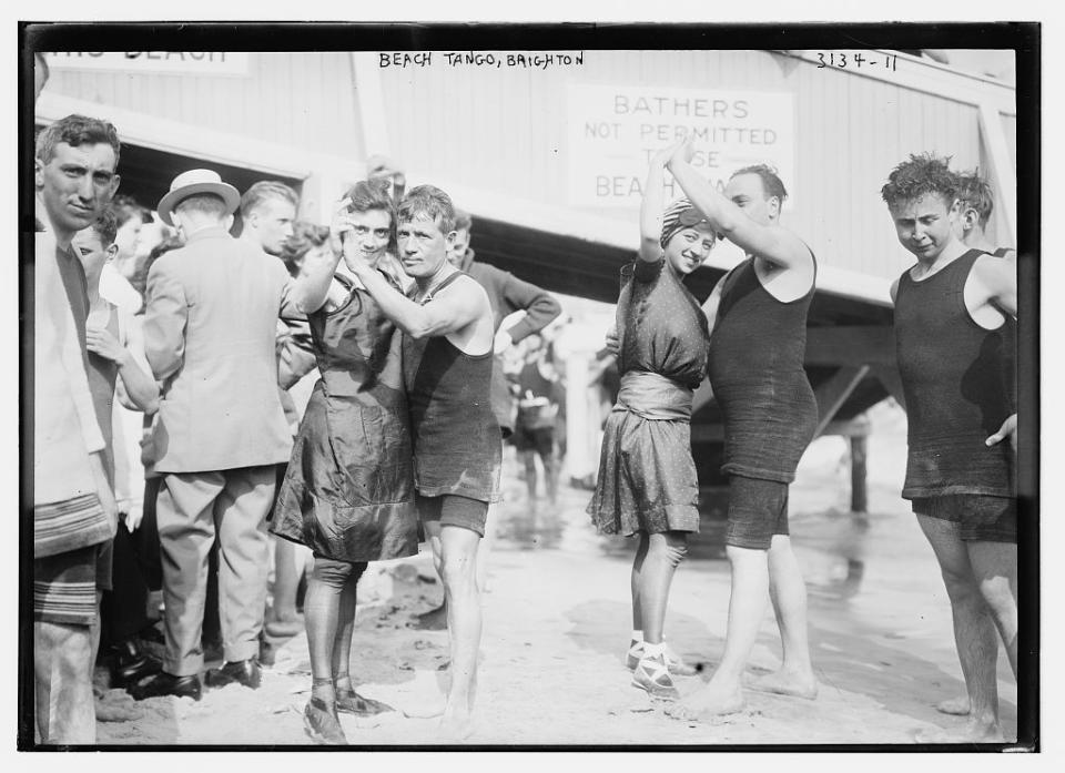 A black-and-white photo of couples dancing in vintage swimwear.