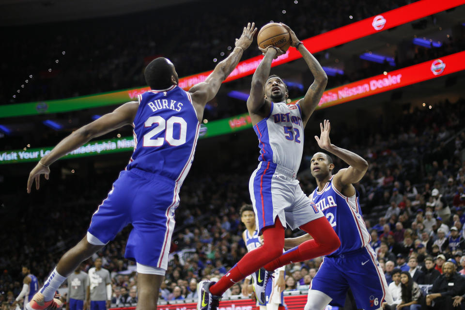 Detroit Pistons' Jordan McRae (52) goes up for a shot between Philadelphia 76ers' Al Horford (42) and Alec Burks (20) during the first half of an NBA basketball game, Wednesday, March 11, 2020, in Philadelphia. (AP Photo/Matt Slocum)