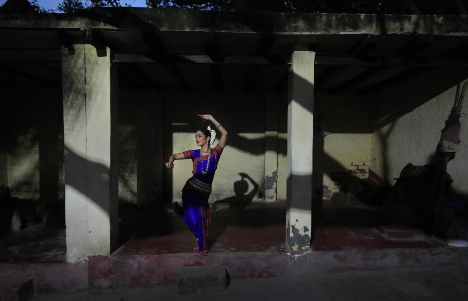 Indian classical Odissi dancer Damini Mehta, 22, poses on the ghats of the river Yamuna, in New Delhi, India, Saturday, Oct. 2, 2021. Mehta, a professional dancer and a young entrepreneur said that she has cultivated a sense of sacred significance with the dance during the pandemic, it has helped her experience familiarity during uncertain times. (AP Photo/Manish Swarup)