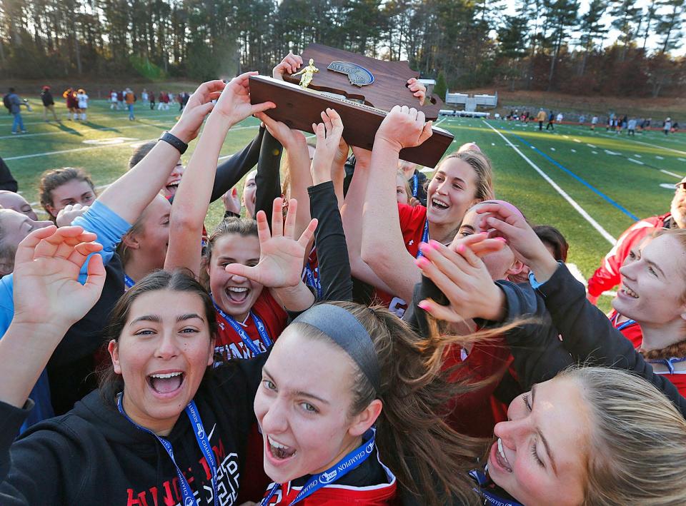 The Harborwomen celebrate with the Division 1 state championship trophy.