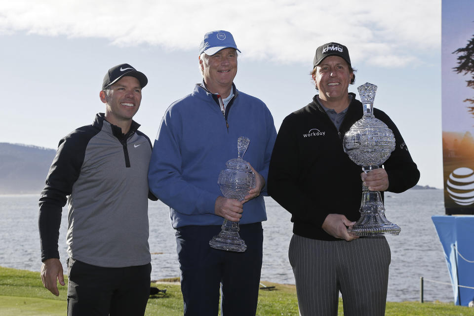 From left, Paul Casey, of England, Don Colleran and Phil Mickelson pose with their trophies on the 18th green of the Pebble Beach Golf Links after the final round of the AT&T Pebble Beach Pro-Am golf tournament Monday, Feb. 11, 2019, in Pebble Beach, Calif. Mickelson won the tournament and Casey and Colleran won the pro-am title. (AP Photo/Eric Risberg)