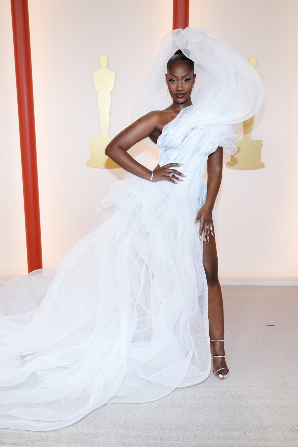 Tems looked angelic at the 2023 Oscars, but also went viral for this view-obstructing gown. (Photo by Kevin Mazur/Getty Images)