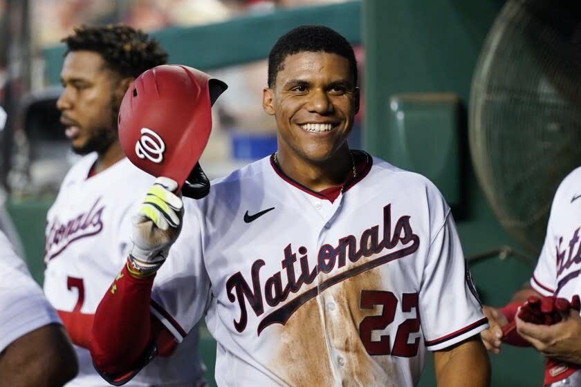 Washington Nationals' Juan Soto smiles as he celebrates after his solo home run during the fourth inning.