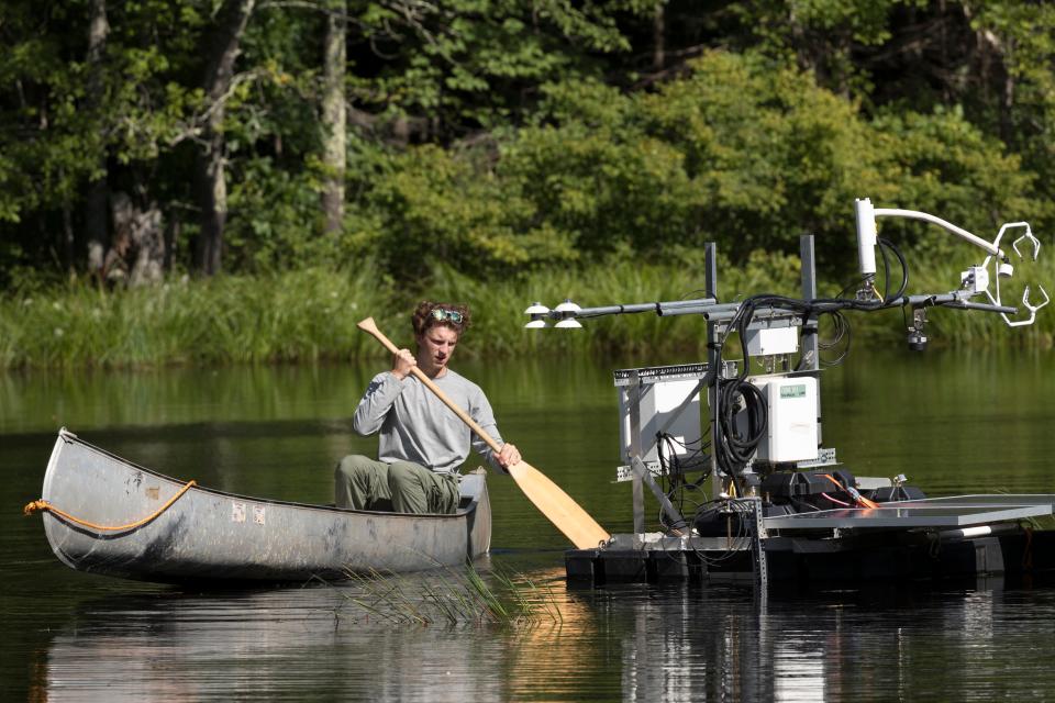 James Mineau, a sophomore at UW-Madison, paddles out to one of 19 flux towers collecting environmental data Aug. 21 in the Chequamegon-Nicolet National Forest outside Park Falls, Wis., as part of a project dubbed CHEESEHEAD19.