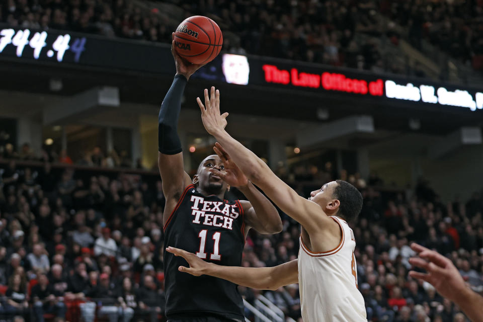 Texas Tech's Bryson Williams (11) shoots the ball over Texas' Dylan Disu (4)during the first half of an NCAA college basketball game on Tuesday, Feb. 1, 2022, in Lubbock, Texas. (AP Photo/Brad Tollefson)