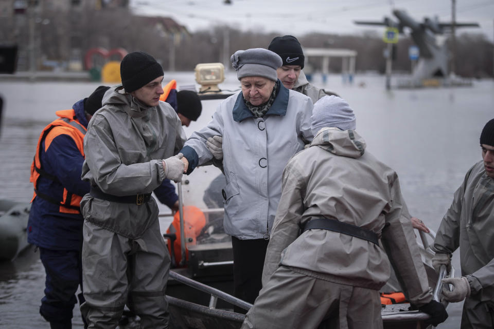 Emergency workers assist a woman to deboard a boat during evacuations local residents in a flooded street after a part of a dam burst, in Orsk, Russia on Monday, April 8, 2024. Floods caused by rising water levels in the Ural River broke a dam in a city near Russia's border with Kazakhstan, forcing some 2,000 people to evacuate, local authorities said. The dam broke in the city of Orsk in the Orenburg region, less than 12.4 miles north of the border on Friday night, according to Orsk mayor Vasily Kozupitsa. (AP Photo)