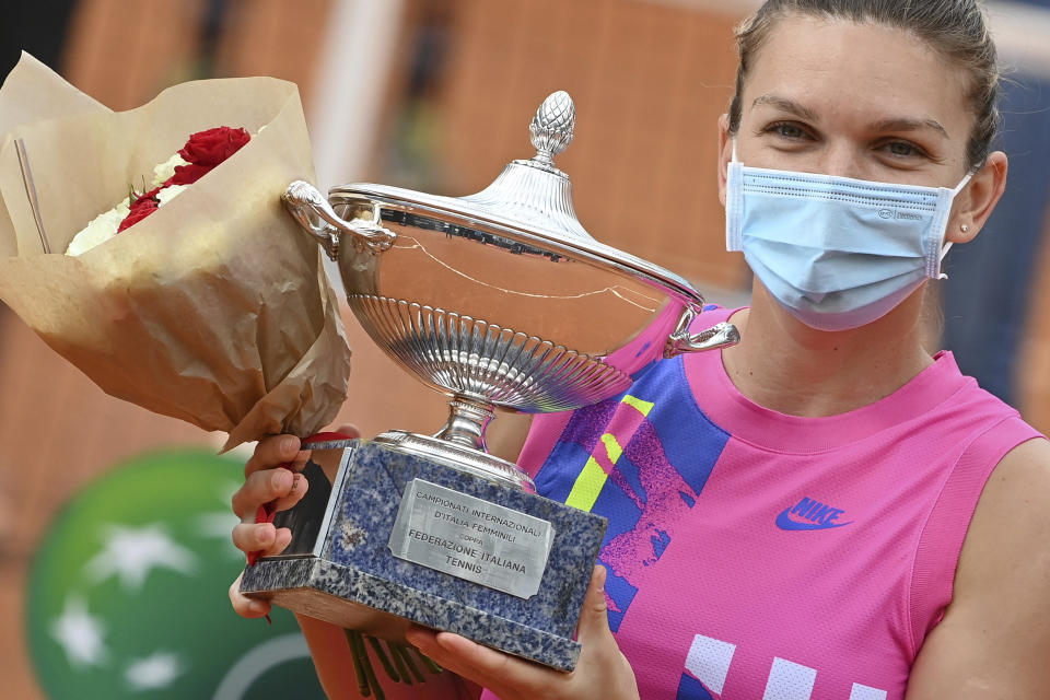 Romania's Simona Halep poses with her trophy after beating Czech Republic's Karolina Pliskova during their final match at the Italian Open tennis tournament, in Rome, Monday, Sept. 21, 2020. (Alfredo Falcone/LaPresse via AP)