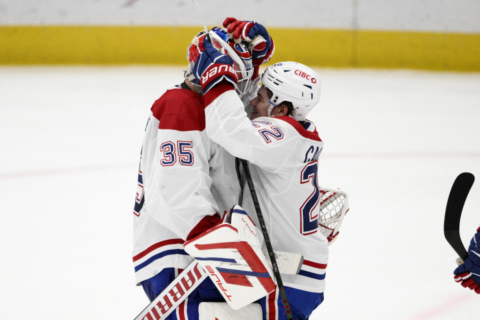 Montreal Canadiens goaltender Sam Montembeault (35) celebrates with right wing Cole Caufield (22) after an NHL hockey game against the Washington Capitals, Tuesday, Feb. 6, 2024, in Washington. The Canadiens won 5-2. (AP Photo/Nick Wass)