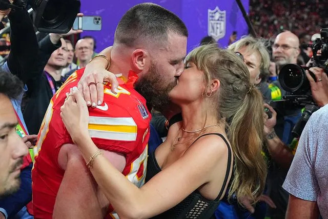 <p>Erick W. Rasco/Sports Illustrated via Getty </p> Travis Kelce and Taylor Swift kiss after the Chiefs’ Super Bowl win on Feb. 11, 2024