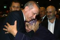 <p>Turkey President Recep Tayyip Erdogan hugs a woman during an event to honor those killed and wounded during the failed July 15 military coup, in Ankara, Turkey, late Friday, July 29, 2016. The government crackdown in the coup’s aftermath has strained Turkey’s ties with key allies including the United States. (AP Photo/Kayhan Ozer Presidential Press Service, via AP Pool) </p>