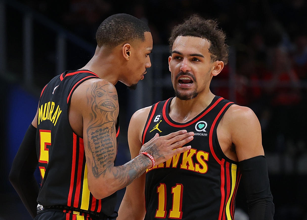 ATLANTA, GEORGIA - APRIL 21:  Trae Young #11 of the Atlanta Hawks reacts after hitting a three-point basket against the Boston Celtics with Dejounte Murray #5 during the fourth quarter of Game Three of the Eastern Conference First Round Playoffs at State Farm Arena on April 21, 2023 in Atlanta, Georgia.  NOTE TO USER: User expressly acknowledges and agrees that, by downloading and or using this photograph, User is consenting to the terms and conditions of the Getty Images License Agreement.  (Photo by Kevin C. Cox/Getty Images)