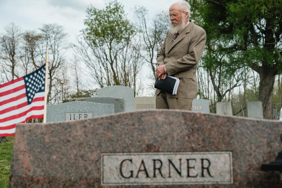 Pastor Lee Randolph of Goshen Community Church of the Nazarene leads a prayer Friday during the military honors ceremony of World War II veteran William Clyde Garner at Patterson-Union Cemetery in Deersville. Garner died in 1980, but was not given honors upon burial at the time.