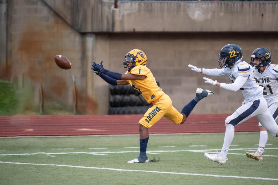 Battle Creek Central's Jesse Coffey (1) reaches for a catch during first half action against Mattawan at C.W.Post Field on Friday, September 23, 2022.