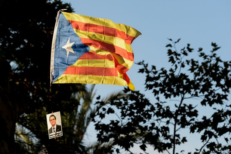 An "Estelada" with a picture of Catalonia's regional government president and leader of the Catalan Democratic Convergence party Artur Mas reading "Artur Mas imputed by 9n" is waved as he arrives at the TSJC on October 15, 2015 in Barcelona