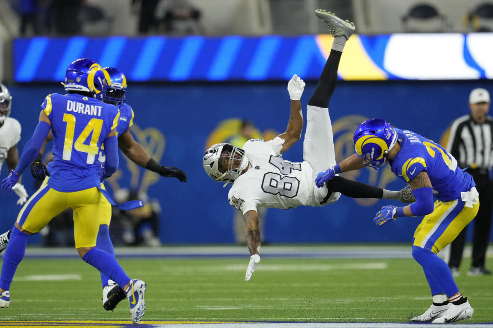 Las Vegas Raiders wide receiver Keelan Cole (84) is hauled down by Los Angeles Rams safety Taylor Rapp, right, during the second half of an NFL football game Thursday, Dec. 8, 2022, in Inglewood, Calif. (AP Photo/Marcio Jose Sanchez)