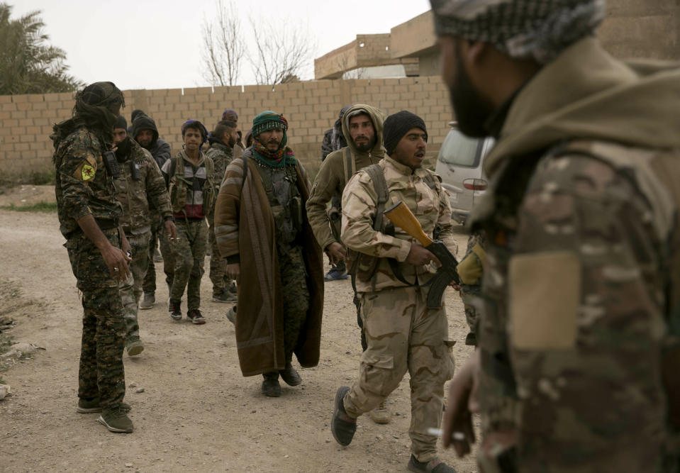 U.S.-backed Syrian Democratic Forces (SDF) gather outside Baghouz, Syria, to go to the front line where Islamic State militants are staging counter attacks, Thursday, March 14, 2019. (AP Photo/Maya Alleruzzo)