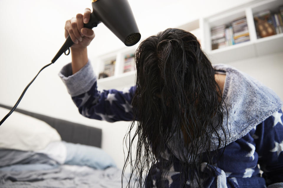 A woman drying her hair.