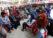 Peolple sit in line as they wait to cast their votes at a polling station during the presidential election in Male, Maldives September 23, 2018. REUTERS/Ashwa Faheem