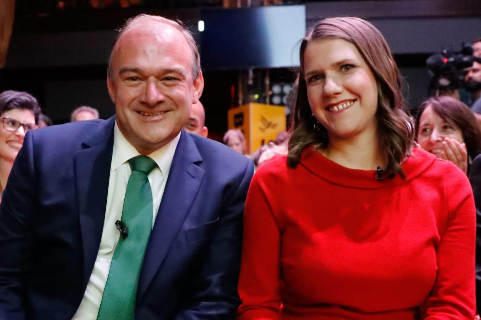 Liberal Democrat leadership candidates Ed Davey (L) and Jo Swinson (R) sit together at an event to announce the new party leader after a leadership contest in central London on July 22, 2019. (Photo by Tolga AKMEN / AFP)        (Photo credit should read TOLGA AKMEN/AFP via Getty Images)