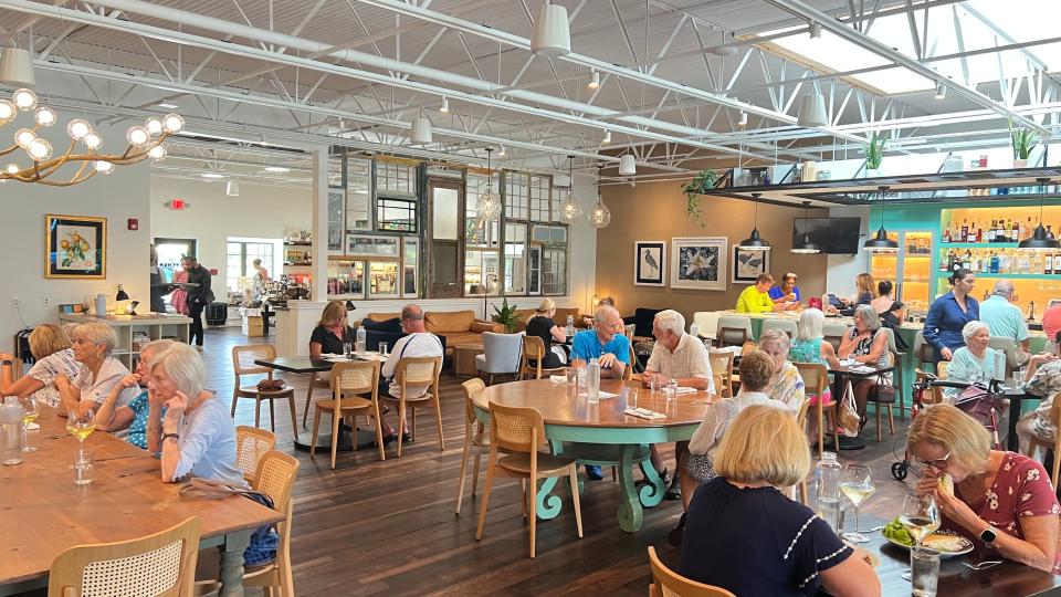 Colab Kitchen in Stuart is a sizable, fresh space with an industrial/farmhouse feel and an open kitchen. The bar has golden backlighting and aqua finishes.