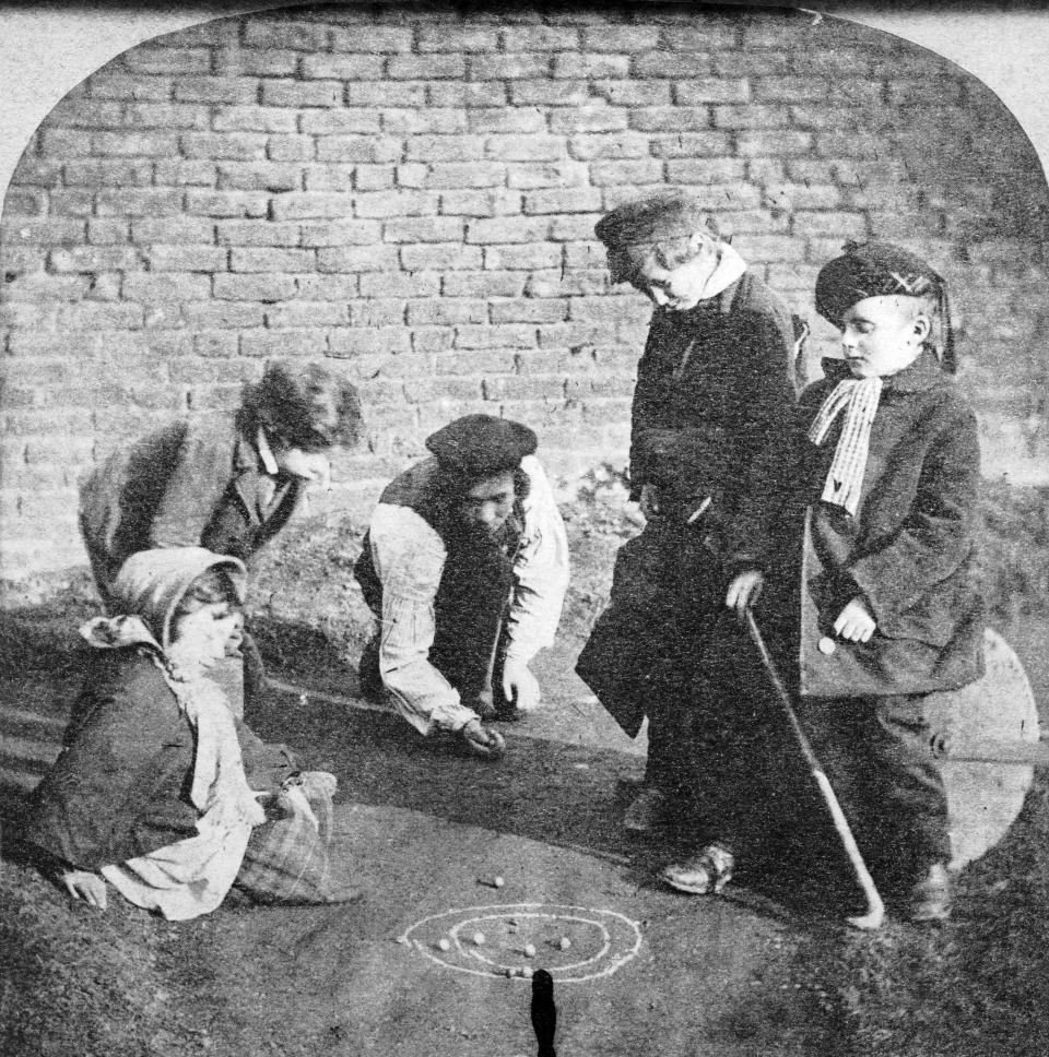 Circa 1855:  A group of children playing marbles.  (Photo by Hulton Archive/Getty Images)