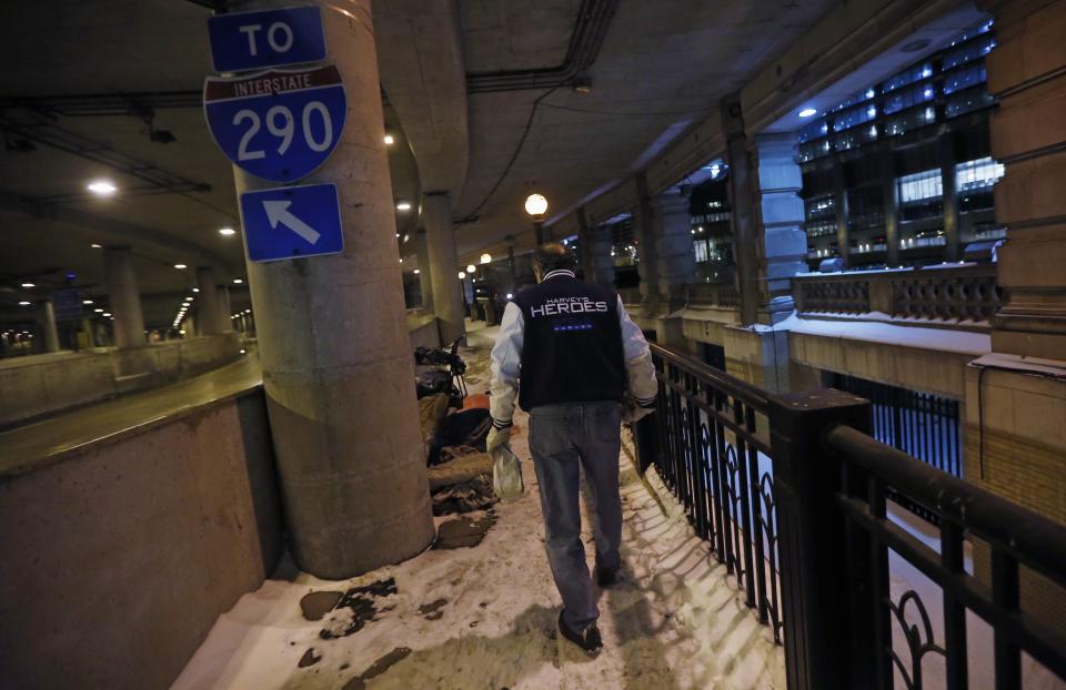 Doctor Angelo carries food to drop off to the homeless under the overpasses on Lower Wacker Drive in Chicago