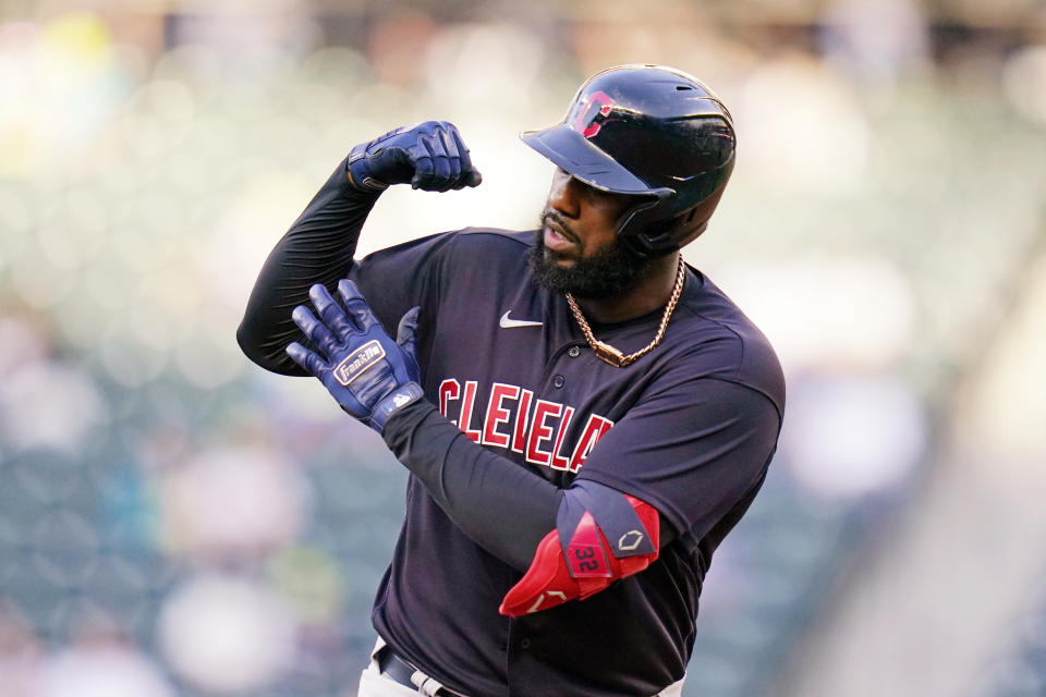 Cleveland Indians' Franmil Reyes shows off his muscle as he rounds the bases on his solo home run against the Seattle Mariners in the second inning of a baseball game Thursday, May 13, 2021, in Seattle. (AP Photo/Elaine Thompson)