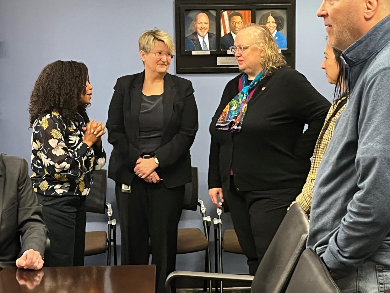 Acting Franklin County Coroner Andrea McCollom, right, chats with Franklin County Board of Commissioners President Erica Crawley, left, and Deputy Administrator Kris Long Thursday at the Franklin County Government Center.