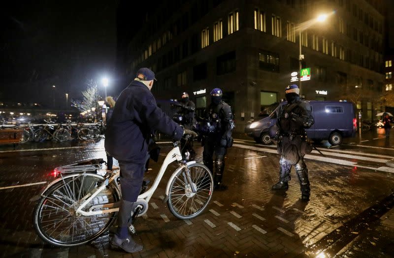 Police guard the streets following Dutch PM Rutte's announcement of new measures to fight a record surge in COVID-19 infections, in The Hague