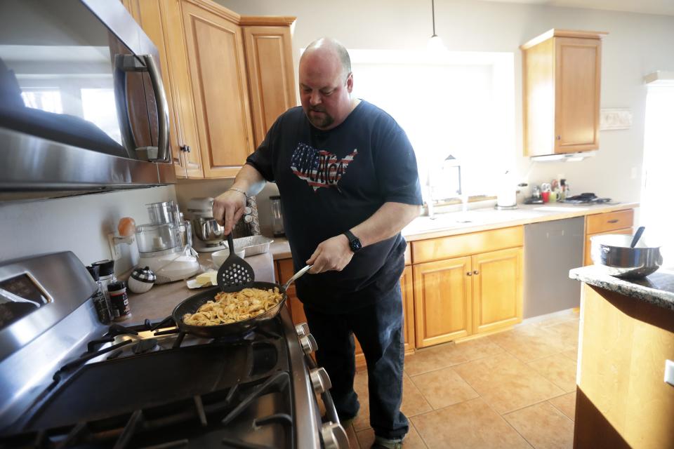 Anthony Richter fries sturgeon with butter and onions to make sturgeon rolls Jan. 30 at his home in Grand Chute. Served over lettuce on a hoagie roll, the sturgeon is first fried in onions and butter then mixed with mayonnaise, Dijon mustard, lemon juice, Creole seasoning, dried mustard powder, celery, green onions and fresh parsley.