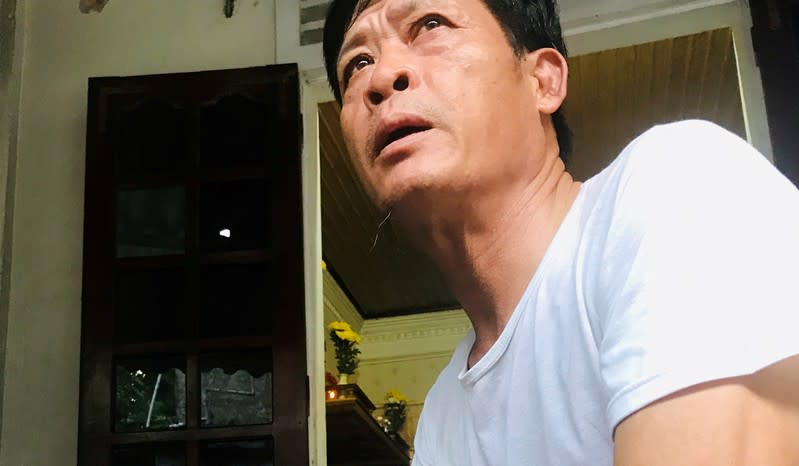 FILE PHOTO: Pham Van Thin, father of Pham Thi Tra My, a suspected victim of 39 deaths on a truck container in UK, sits at home in Ha Tinh province