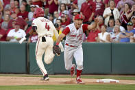 North Carolina State first baseman Austin Murr (12) reacts after making the game ending out on Arkansas base runner Jalen Battles (4) as they win 3-2 to and advance to the College World Series during an NCAA college baseball super regional game Sunday, June 13, 2021, in Fayetteville, Ark. (AP Photo/Michael Woods)