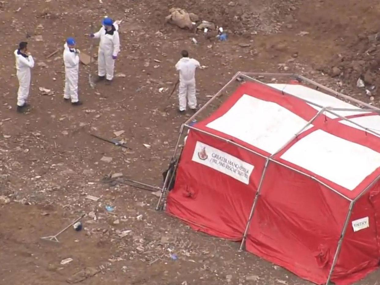 Police staff in forensic suits search a Viridor Waste Management site at Pilsworth, near Bury: Sky News screengrab