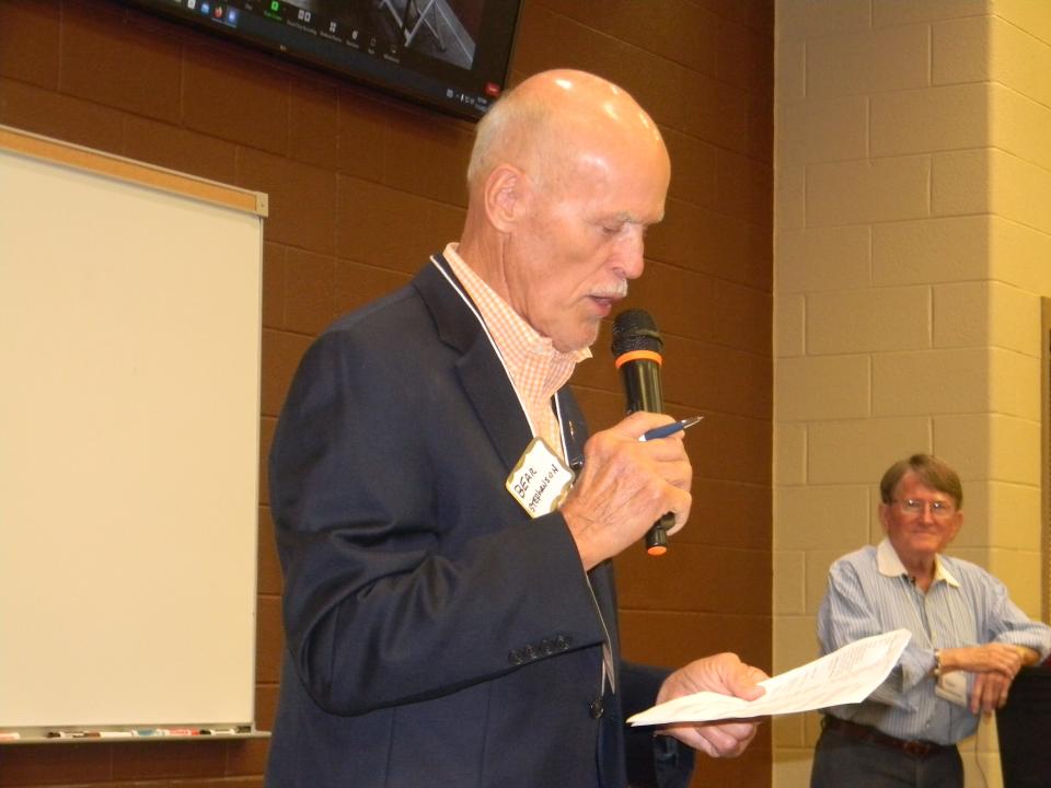 William "Bear" Stephenson introduces candidates at a League of Women Voters event while Dan Robbins director of the League of Women Voters listens on.