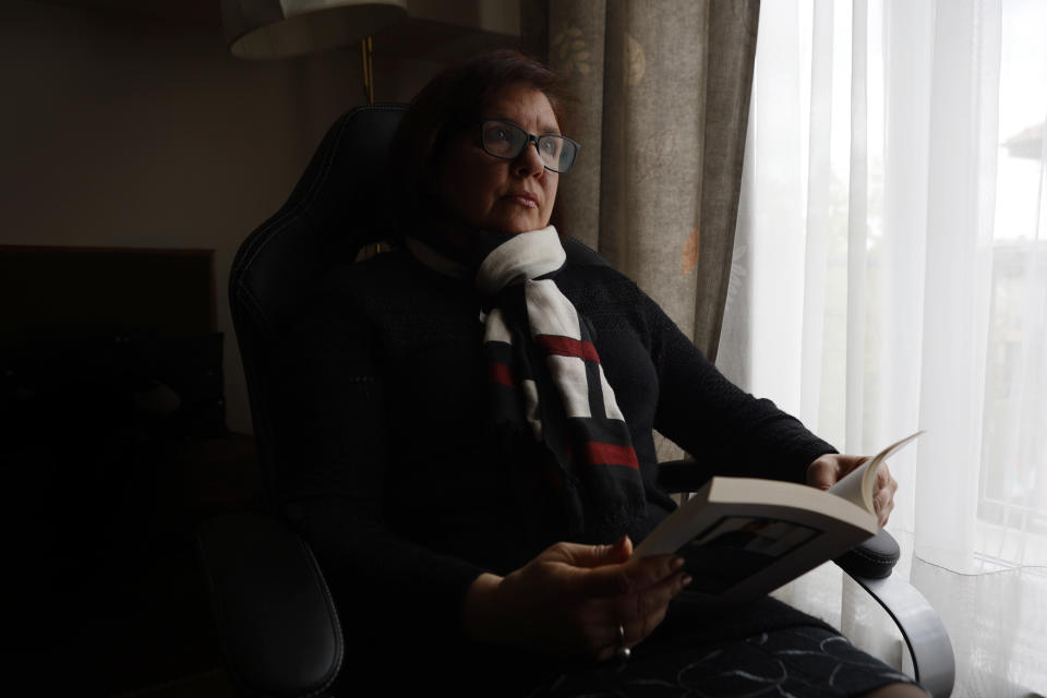 Veselina Marinova, an editor who lives with her husband and 83-year-old mother in Sofia, Bulgaria, holds a book at her office, Monday, April 18, 2022. Rising energy prices in Europe are testing the resolve of those caught between a dependence on cheap Russian energy and their revulsion at Moscow’s war in Ukraine. For Marinova paying more for energy is a small sacrifice when weighed against the deaths of civilians in Ukraine. (AP Photo/Valentina Petrova)