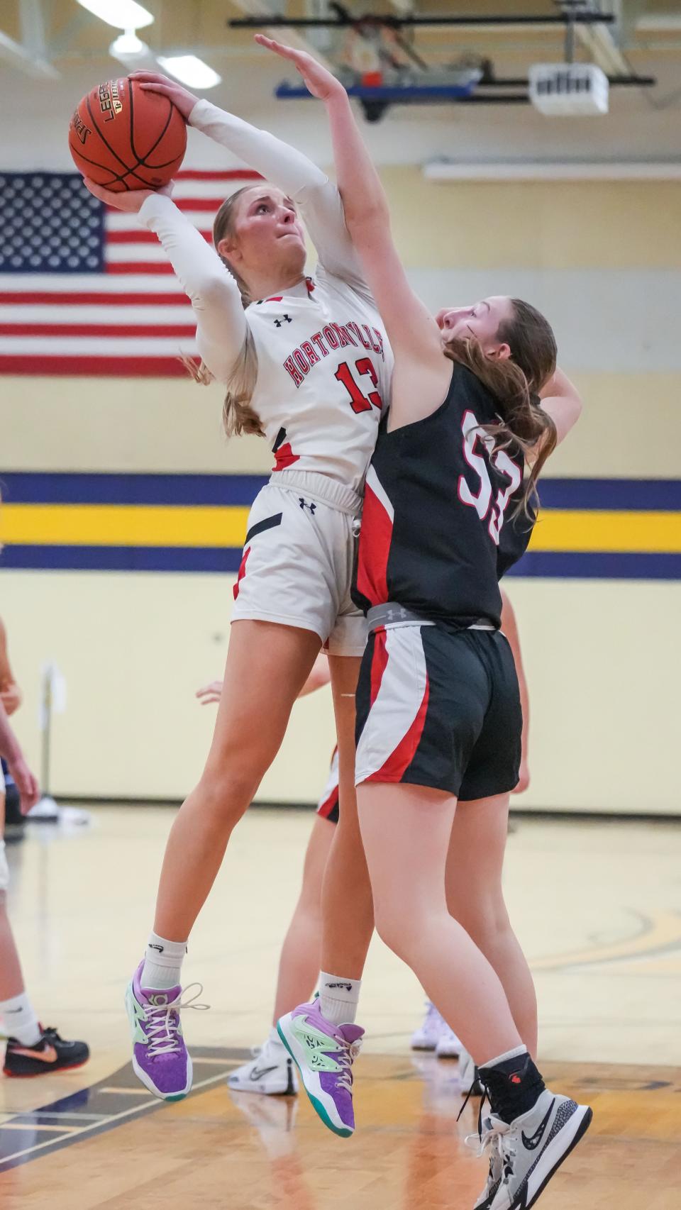 Hortonville's Mikayla Werner (13) puts up a shot over Pewaukee's Maddie Chabot during a game at the Kettle Moraine Thanksgiving Classic girls basketball tournament on Nov. 24.